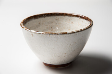 Close of vintage white and brown ceramic bowl on white