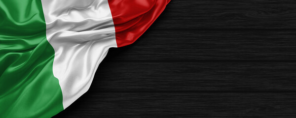 Close Up of Italy flag on the black wooden background 3D render