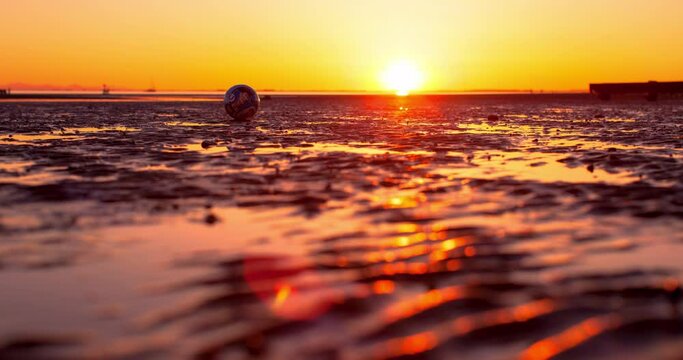 Time Lapse Beautiful Shot Of Ball Over Landscape, People Exploring Beach During Sunset - Vancouver, Canada