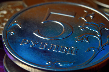 Russian 5 ruble coin is highlighted in blue and red. close-up.