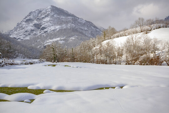 Small house in snowy mountain valley