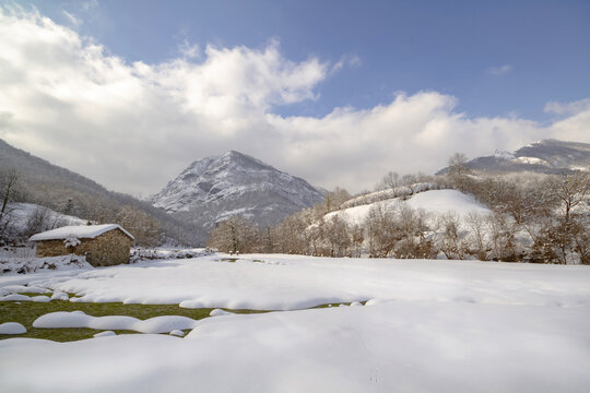 Small house in snowy mountain valley