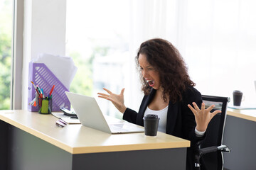Happy excited successful Beautiful hispanic businesswoman angry  in modern office with laptop. Work from home