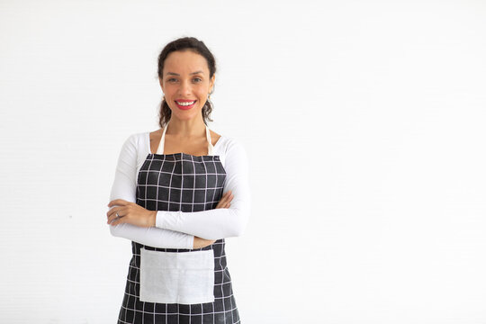 Portrait Of Smiling Young Woman In Apron  Looking At Camera Isolated On White Background