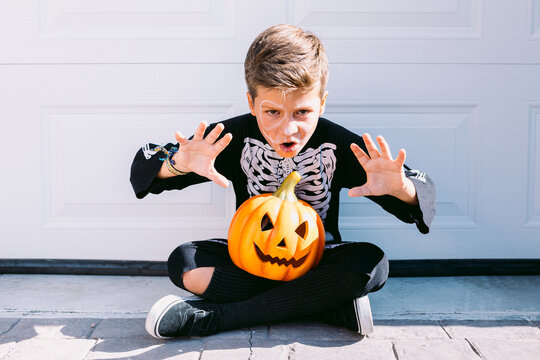 Kid doing boo gesture during Halloween holiday