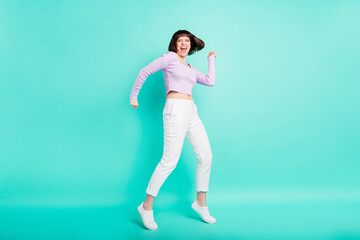 Fototapeta na wymiar Full length photo of impressed cute young lady wear purple pullover dancing smiling isolated teal color background