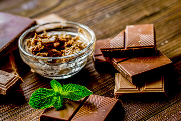 chocolate pieces with mint on wooden table background
