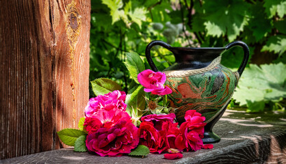 Bouquet of red roses and ceramic vase. Vintage.