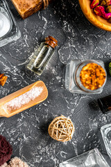 bathroom salt and natural soap for spa on dark background top view