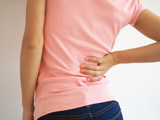 Asian woman showing back pain on a white background. medical concept.