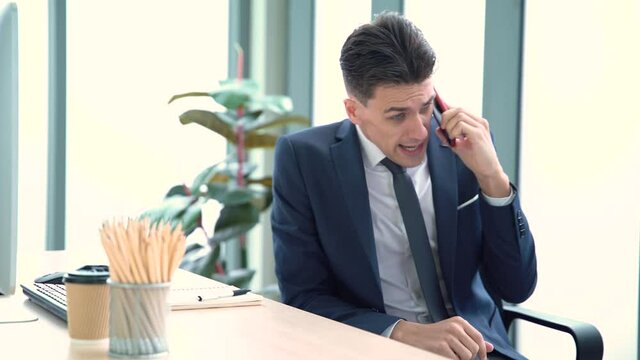 business man talking on the phone in anger aggressive verbs at work