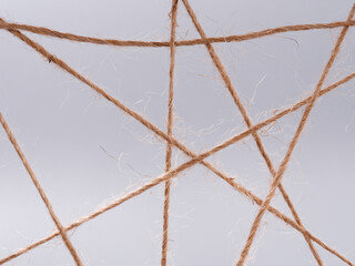 routine network spider web of coarse threads on gray background