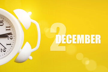 December 2nd. Day 2 of month, Calendar date. White alarm clock on yellow background with calendar day. Winter month, day of the year concept.