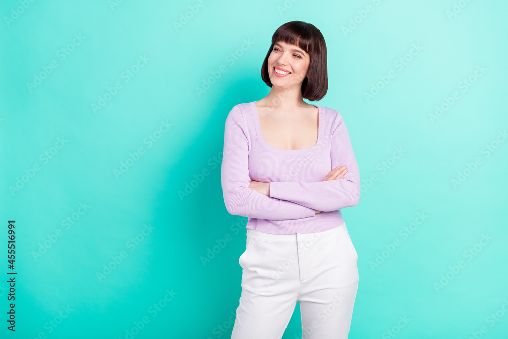 Canvas Prints Photo portrait business woman looking copyspace smiling with crossed hands isolated bright teal color background