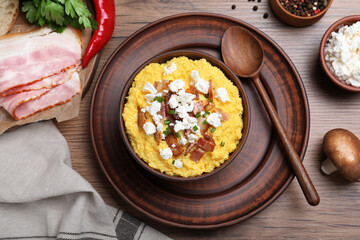 Delicious traditional banosh served on wooden table, flat lay