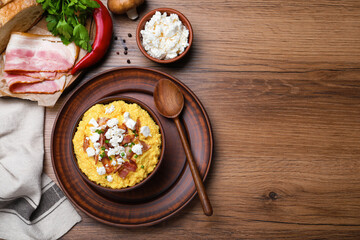 Delicious traditional banosh served on wooden table, flat lay. Space for text
