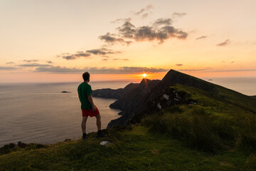 Man looking at the view of Croaghaun Cliffs on Achill Island Ireland