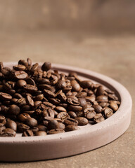 Coffee beans close-up. Macro photography of coffee on a brown background. A place for text in food photos. Arabica.