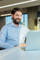 Fototapeta premium businessman working on laptop with smiley face 