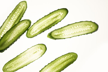 Cucumber green slices pattern isolated on white background. Creative cucumbers wallpaper, food backdrop design