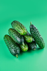 Set of fresh whole cucumbers isolated on a green background, clipping path. Garden cucumber wallpaper backdrop design