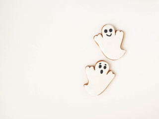 Minimal Halloween composition with gingerbread cookies - ghosts on white background