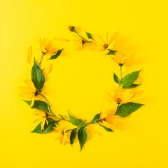 Flowers composition. Wreath made of yellow flowers on yellow background. Flat lay, top view, copy space for text. Square
