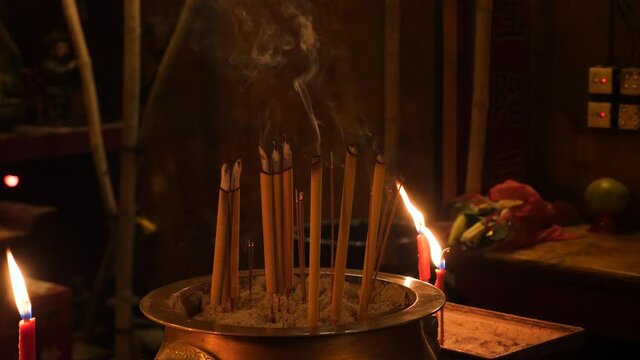 Inside the Man Mo temple located in the Cental distict of Hong Kong. Smoke incense sticks.