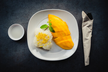 Top view of he mango with sticky rice on the grey concrete table, the traditional famous thai...