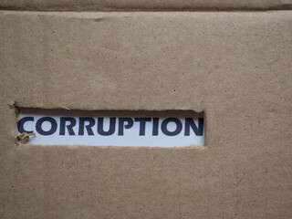 Corruption, word on piece of torn cardboard, Social problematic concept