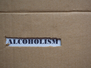 Alcoholism, word on piece of torn cardboard, Social problematic concept