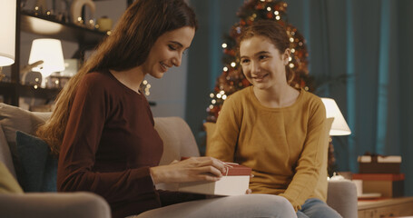 Woman receiving a Christmas gift from her sister