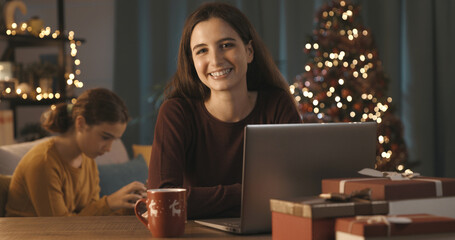 Smiling woman connecting online on Christmas day