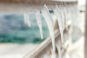 Frozen jetty with icicles on the handrails
