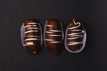 Eclair or Chocolate Bomb. Brazilian traditional éclair on a black background.