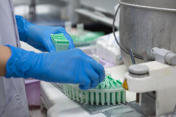 Medical scientists are preparing biopsies in the laboratory for pathologists to diagnosis ,select...