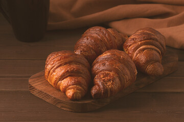 Pastries,Croissants on a brown wooden table, breakfast, no people, rustic style, top view, 