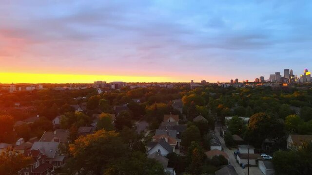 Aerial view of a beautiful sunset in Minneapolis suburbs area during golden hour, homes houses