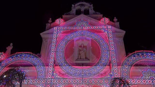 Decorative illuminations in front of the church of Saint Dominic at night for the Patron Saint celebration, Marina di Camerota, Italy 