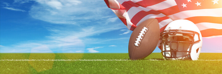 American Football helmet and ball on field with USA flag.