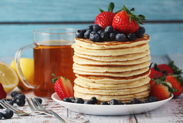 A stack if home-made pancakes with berry