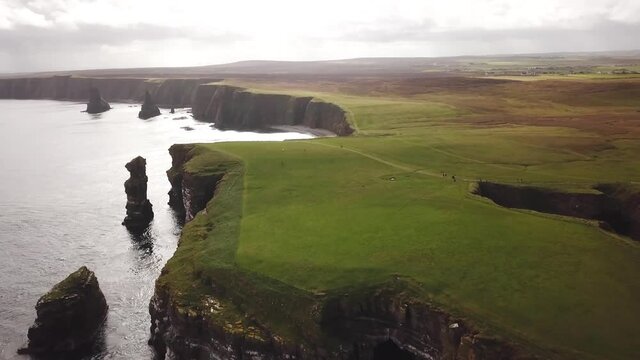 4K Aerial shot of the dramatic coast line of Duncansby Head in Scotland. Scotland highlands nature. Drone shot of dramatic sea stacks at Duncansby Head near John O' Groats in Scotland. 