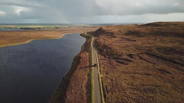 4K Aerial view of empty road with one car, Thurso, Dunnet Head, Scotland.