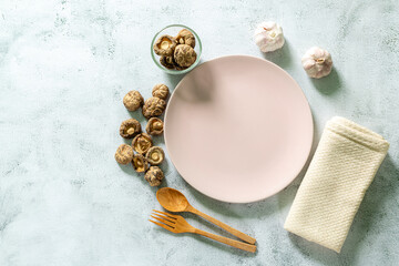 Ceramic plate with cutlery on white surface.,Empty white plate on gray concrete stone background. Top view, copy space