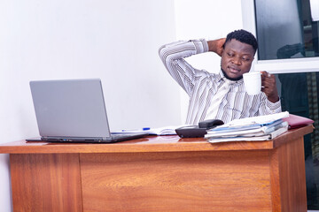 adult businessman holding a cup of coffee in the office.