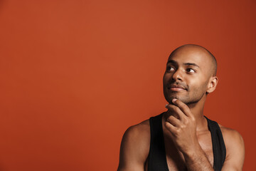 Black bold man wearing shirt posing and looking aside