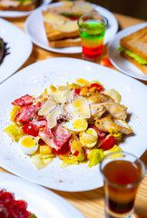 Caesar salad with parmesan cheese served for lunch in restaurant