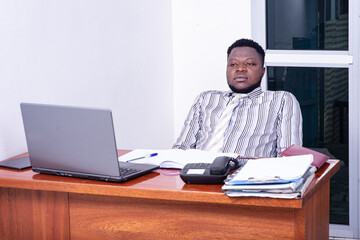 calm adult businessman sitting at desk.