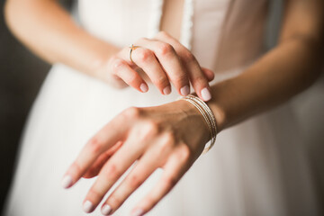 Beautiful bride wearing fashion wedding dress with feathers with luxury delight make-up and hairstyle, studio indoor photo shoot
