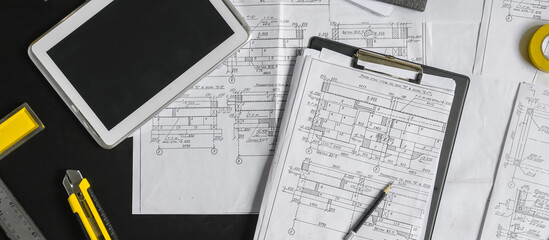 Architect works remotely from home in quarantine, lockdown covid 19 coronavirus. Remote work, stay home, new normality, social distance. Architect design working drawing sketch plans blueprints